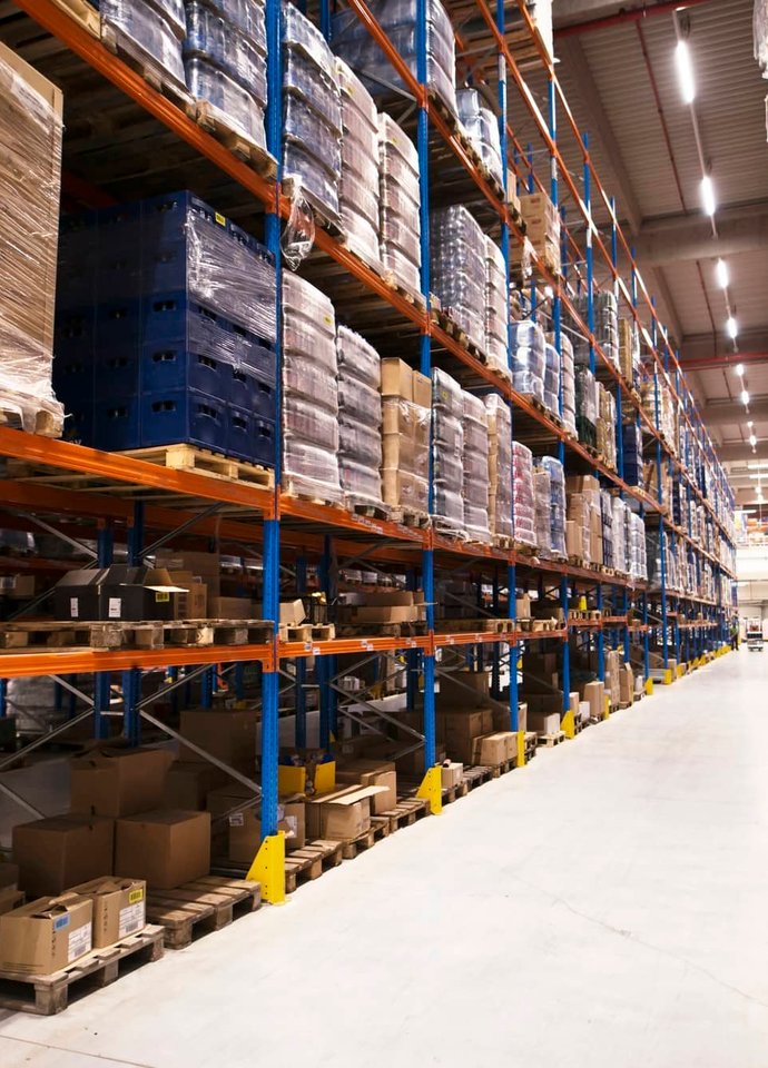 Warehouse racking stacked with palletised goods.